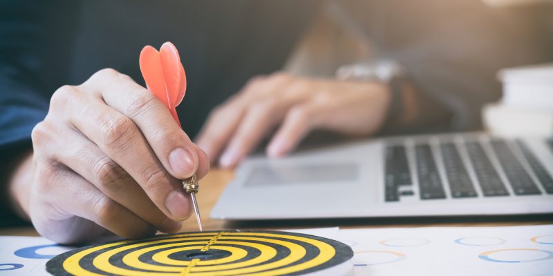 Business strategy success target goals. Businessman holding red dart push on target. Business strategy planning success target goals. Business development concept